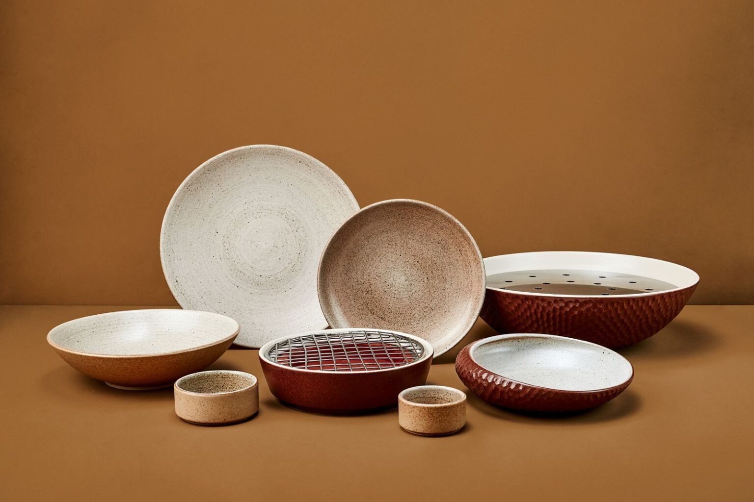 Bespoke ceramic tableware by Kevala Ceramics for Café Kitsuné, featuring refined minimalist forms and warm tonal finishes